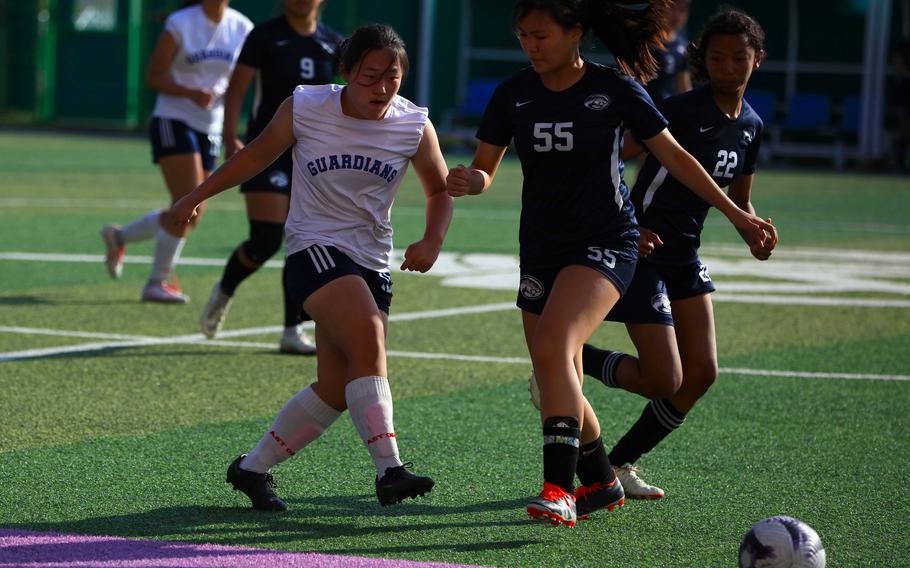 Yongsan International-Seoul’s Ludia Yoo boots the ball past Osan‘s Katherine Tran during Saturday’s Korea postseason girls soccer tournament match. The Guardians won the fifth-place match 3-0 over the Cougars.