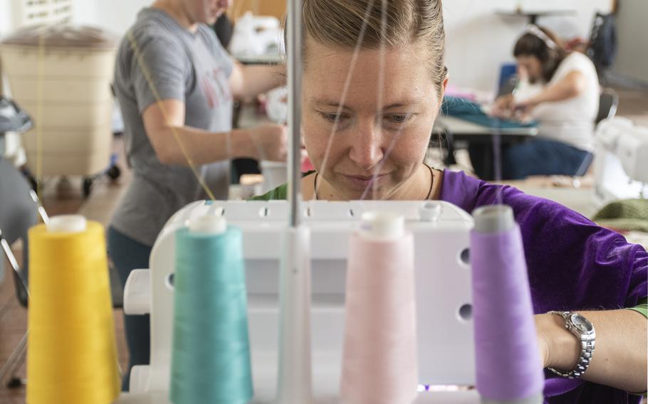 Lauren Williams sews a prayer garment for Afghan refugees at Ramstein Air Base on Aug. 26, 2021.