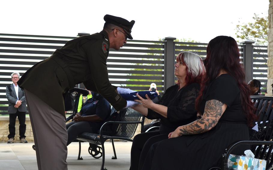 Cheri Stripling, the great-niece of Army Air Forces 2nd Lt. Wayne Dyer, accepts a folder flag during the burial service for Dyer on Monday, April 10, 2023, at Central Texas State Veterans Cemetery in Killeen, Texas. Dyer died during combat May 29, 1944, and the Defense POW/MIA Accounting Agency identified his remains in September.