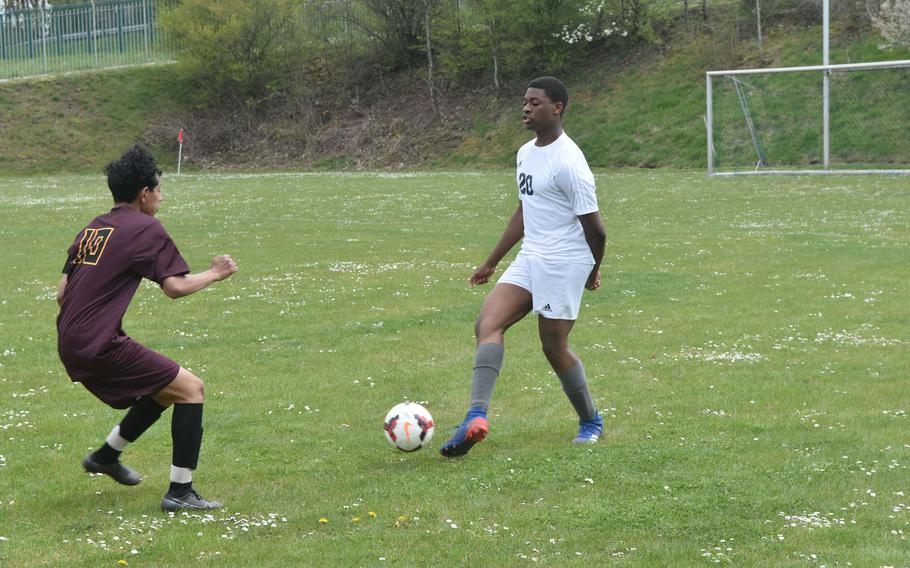 Ansbach's Josiah Quinland attempts to pass the ball while Baumholder's Antonio Robles defends on Saturday, April 23, 2022 during a soccer match in Baumholder, Germany.