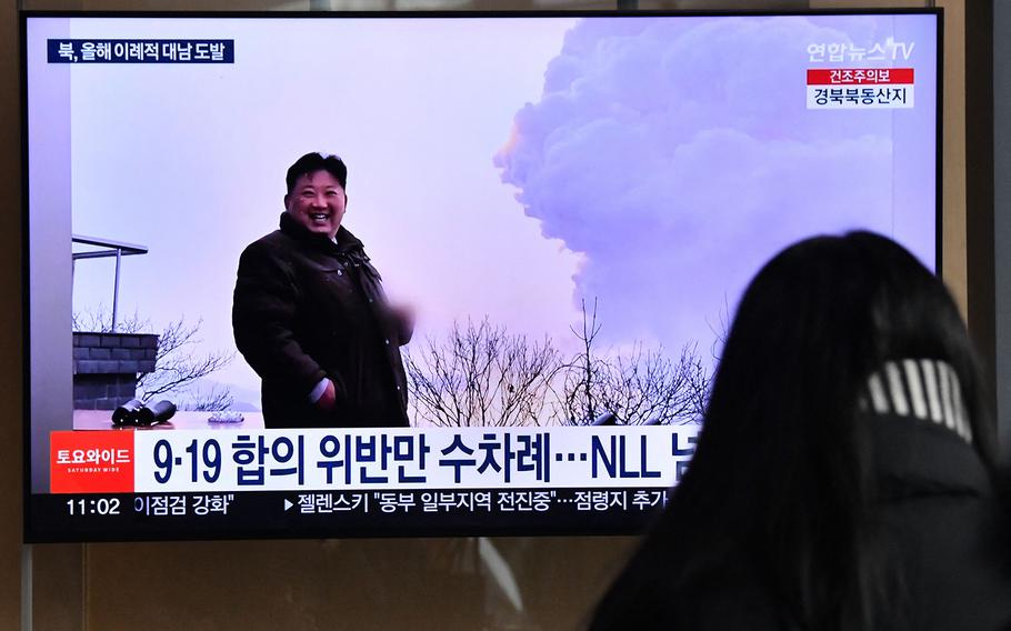 A woman watches a television screen showing a news broadcast with file footage of North Korean leader Kim Jong Un, at a railway station in Seoul on Dec. 31, 2022, after North Korea fired three short-range ballistic missiles according to South Korea's military.