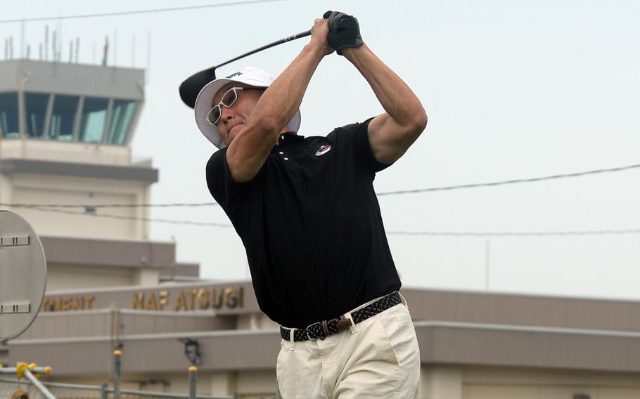 Chong Delisi swings a golf club.