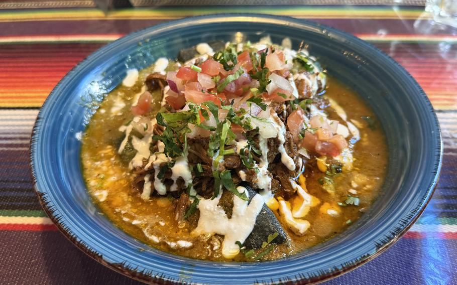 A helping of  stuffed chilaquiles on a blue plate.