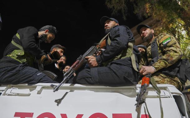 Syria's security forces stand on their vehicle, after reaching a deal with Druze gunmen to deploy around Jaramana, a Damascus suburb that saw fighting earlier this week, in Damascus, Syria, early Friday, May 2, 2025. (AP Photo/Omar Sanadiki)
