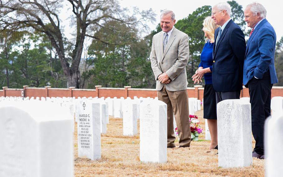 The children of Lt. Gen. Hal and Julia Moore, for whom Fort Benning will be renamed, visit their parents’ grave on the Georgia Army post on Feb. 17, 2023. Pictured from left to right are Dave Moore, Cecile Moore Rainey, Steve Moore and Greg Moore, who along with their sister Julie Moore Orlowski, nominated their parents as the new namesakes for Fort Benning after Congress began the process to rename installations named for Confederate generals in 2021.