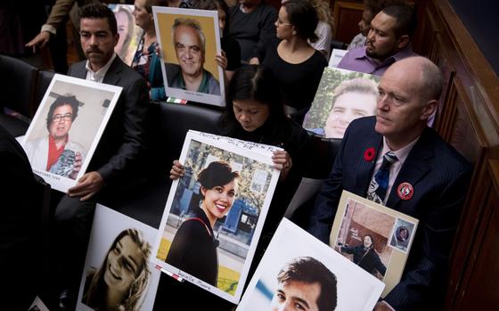 Family members of Boeing Co. 737 Max crash victims hold photographs before the start of a House Transportation and Infrastructure Committee hearing in Washington, D.C., U.S., on Wednesday, Oct. 30, 2019. Boeing Co. Chief Executive Officer Dennis Muilenburg yesterday declined to endorse specific reforms to bolster safety oversight of the aerospace giant during a sometimes angry grilling in his first appearance before Congress since two 737 Max crashes killed 346 people. MUST CREDIT: Bloomberg photo by Andrew Harrer