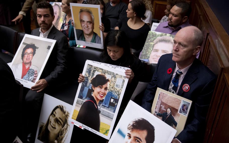 Family members of Boeing Co. 737 Max crash victims hold photographs before the start of a House Transportation and Infrastructure Committee hearing in Washington, D.C., on Oct. 30, 2019.