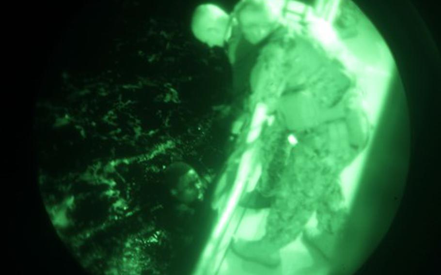 Crew members of the U.S. Coast Guard cutter Glen Harris pull migrants from the Atlantic Ocean on Jan. 5, 2022.