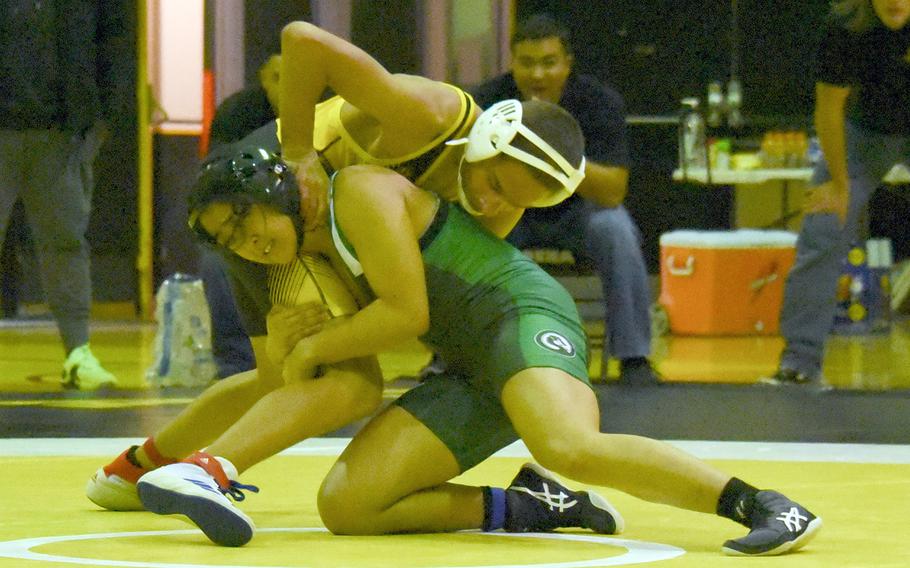 Kubasaki's Gwen Panteleone takes command of Kadena's Jaden Green at 101 pounds during Wednesday's Okinawa wrestling dual meet. Panteleone pinned Green in 54 seconds and the Dragons won the meet 39-26.