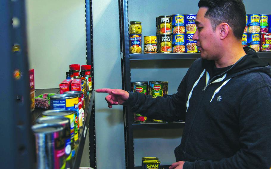 A service member chooses items from the food pantry at Yokota Air Base, Japan, during a government shutdown, Jan. 24, 2019.