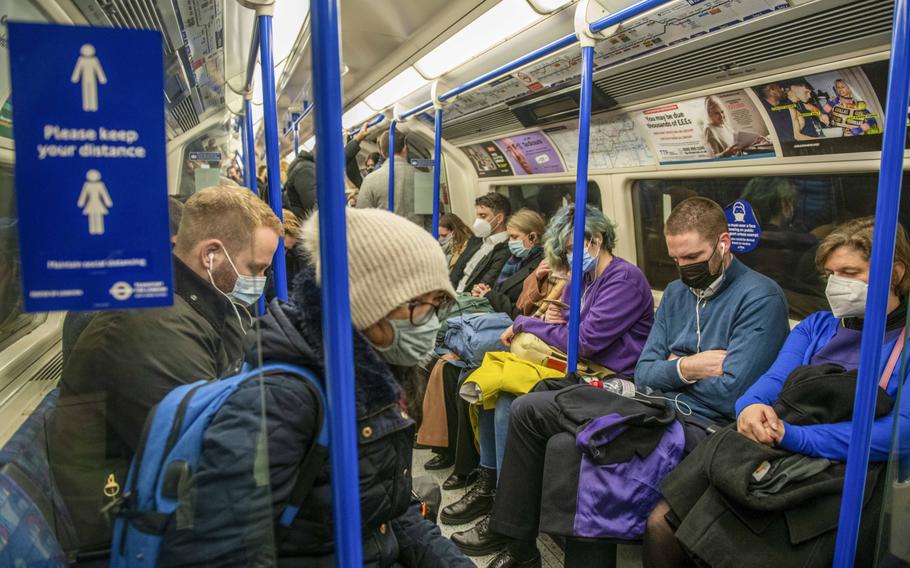 Commuters on a London Underground train on the Central Line at Bank station on Nov. 30, 2021. 