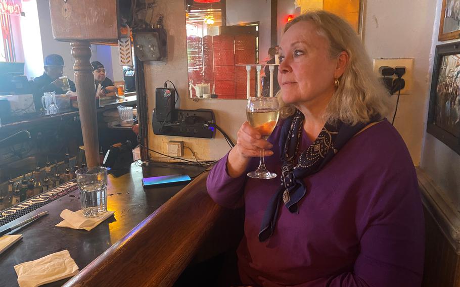 Kimberly Ashworth, a retired federal policy analyst, enjoys a white wine at Harry’s on Nov. 17. The Harrington’s in-house dive bar stopped serving Dec. 3 after 30 years.