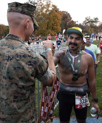 A runner receives a medal after finishing the 48th Marine Corps Marathon on Sunday, Oct. 29, 2023, in Arlington, Va.