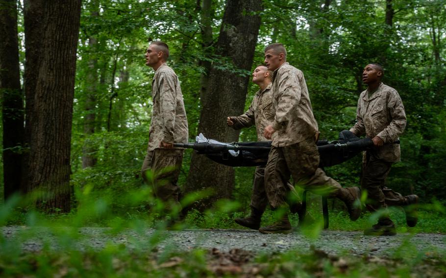 Marines carry a stretcher.