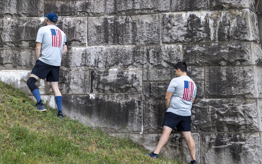 Runners relieve themselves below the Arlington Memorial Bridge
