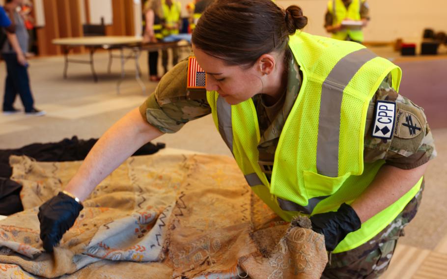 An Army reservist prepares a make-believe artifact for transport during the five-hour training drill. 