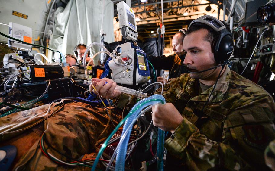 Senior Airman Jack Stine, a respiratory therapist with the 86th Aeromedical Evacuation Squadron, secures breathing equipment for a medical mannequin aboard a C-130 Hercules on June 6, 2023. The mannequin can simulate ciruclation, heartbeat and breathing to give medical technicians realistic training scenarios.