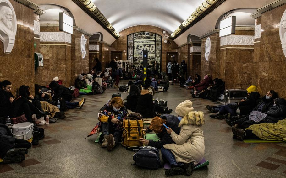 People shelter in a metro station in Kyiv on Feb. 25, 2022, a day after Russia began its invasion of Ukraine. 