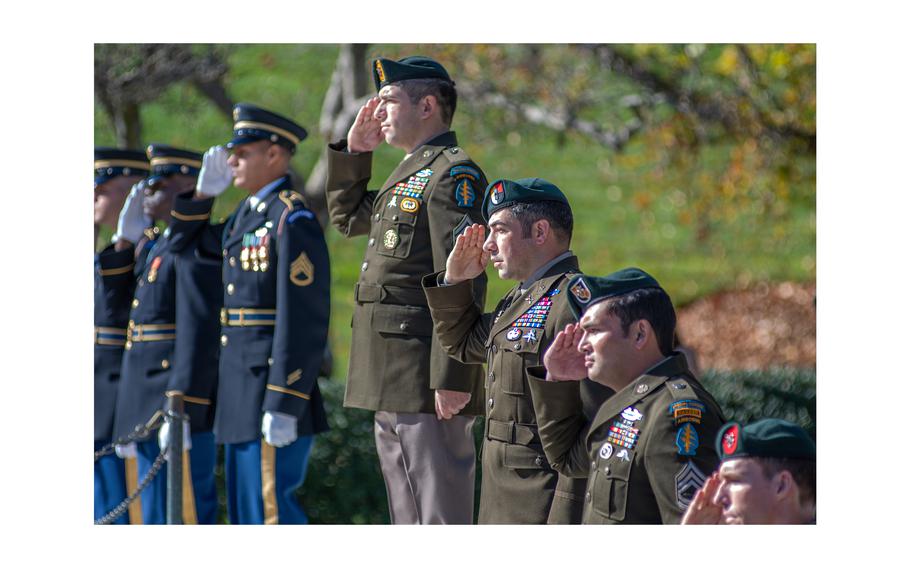 Army Green Berets and honor guard members salute at Arlington National Cemetery where a wreath laying ceremony was held on Nov. 8, 2023, to commemorate former President John F. Kennedy’s contributions to Special Forces. The ceremony took place at Arlington’s Eternal Flame, a memorial at JFK’s gravesite. The former president was assassinated six decades ago on Nov. 22, 1963.