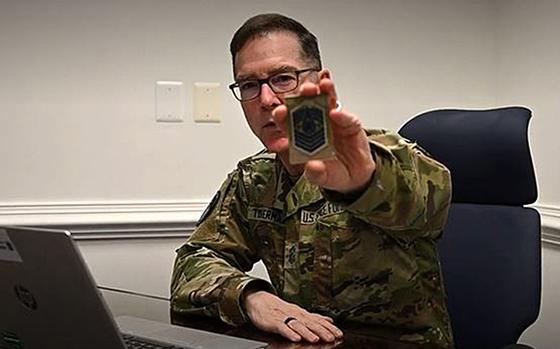 Chief Master Sgt. of the Space Force Roger A. Towberman shows off a prototype rank insignia patch to be worn on the Space Force camouflage uniform, in a video posted on an Air Force network, Feb. 4, 2022.