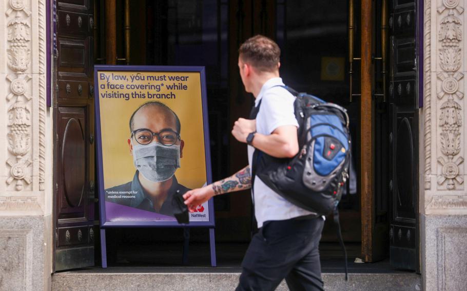 A sign informing customers they must wear a mask at the entrance to a NatWest Group bank branch in the City of London on June 7, 2021. 