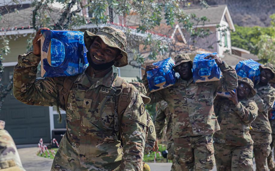 Soldiers with the 25th Infantry Division distribute water door-to-door at Aliamanu Military Reservation, Hawaii, Dec. 2, 2021. It is one of 10 military communities near Joint Base Pearl Harbor-Hickam affected by petroleum contamination of their drinking water.