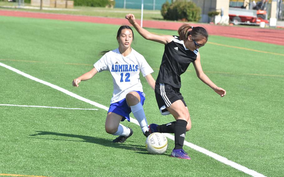 Rota’s Shelby Jonroe, left, and Vicenza’s Julia Rudy try to gain control of the ball in the Cougars’ 7-0 victory on Friday, April 29, 2022.