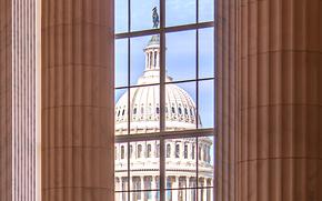 The U.S. Capitol seen through a window of the House Canon building.