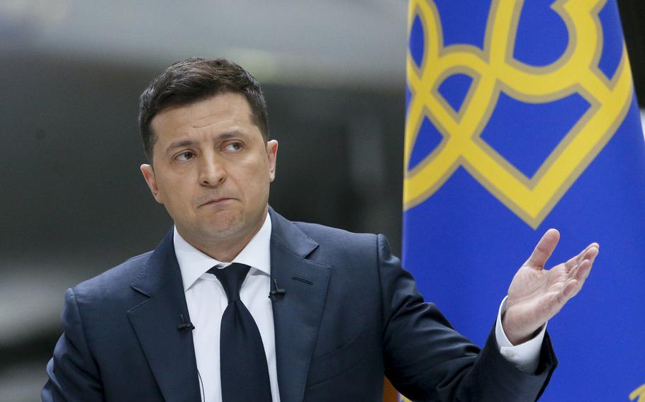 Ukrainian President Volodymyr Zelenskyy gestures while speaking to the media during a news conference with the Ukrainian Antonov An-225 Mriya airplane in the background at the Antonov aircraft factory in Kyiv, Ukraine, on Thursday, May 20, 2021.