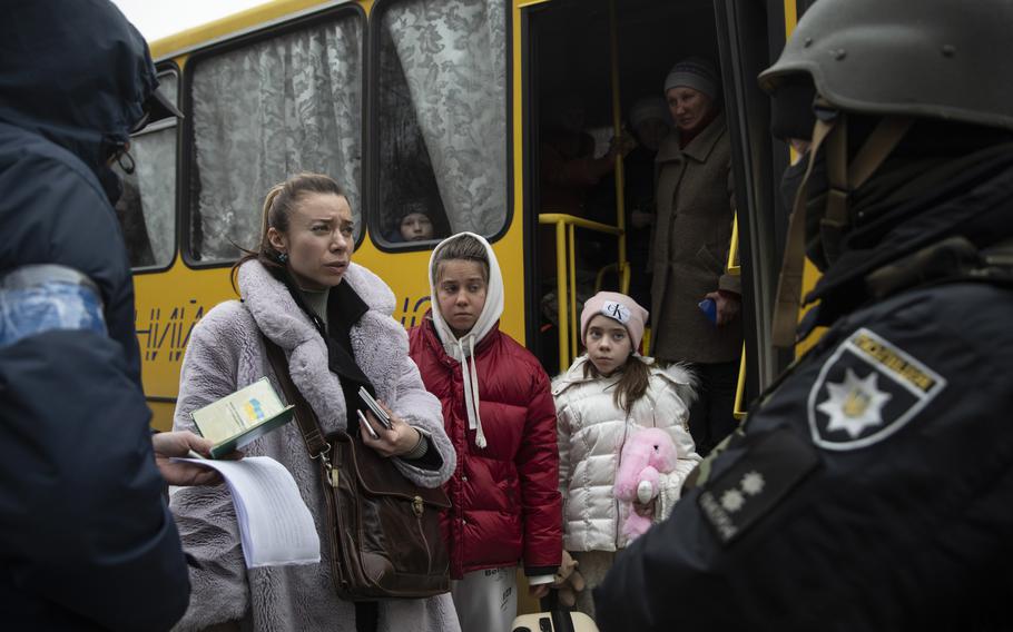 A family arrives on a bus in Brovary with hundreds of others evacuated from the area of Velyka Dymerka on March 13.