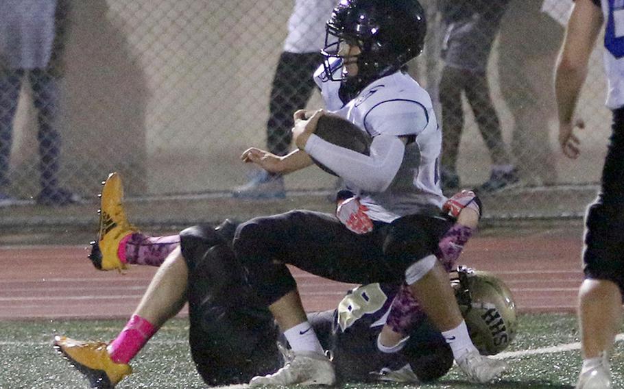 Osan's Adam Rutland is hauled down by Humphreys Gold's Lucas Bochat after intercepting a pass.