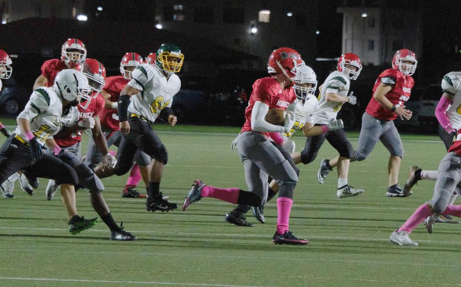 Nile C. Kinnick’s Kou Nishiyama runs the ball after catching a kickoff from Robert D. Edgren’s football team.