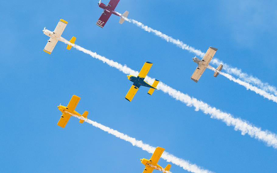 Six airplanes fly in formation in the sky