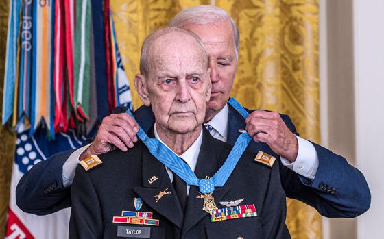 President Joe Biden during a ceremony at the White House on Tuesday, Sept. 5, 2023, places the Medal of Honor around retired Army helicopter pilot Capt. Larry Taylor, who was recognized for his heroic actions during the Vietnam War when led a mission in 1968 to save a small group of soldiers trapped in a rice field by enemy fire.