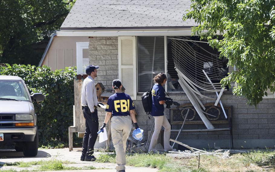 Law enforcement investigate the scene of a shooting involving the FBI on Wednesday, Aug. 9, 2023, in Provo, Utah. A man accused of making threats against President Joe Biden was shot and killed by FBI agents hours before the president was expected to land in the state, authorities said.