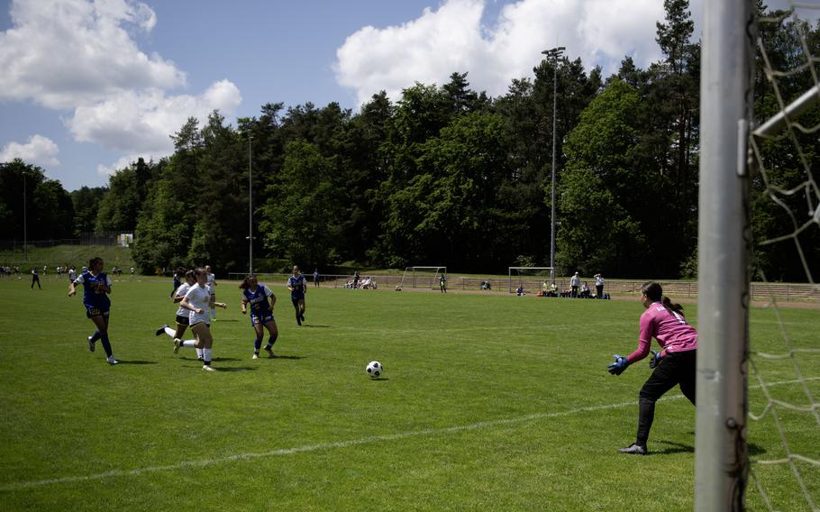 Charlize Caro of Sigonella takes a shot at goal as Ansbach's Kennedy Lange prepares to jump for the ball during the 2024 DODEA European Soccer Division III Championships in Landstuhl, Germany, on May 20, 2024.