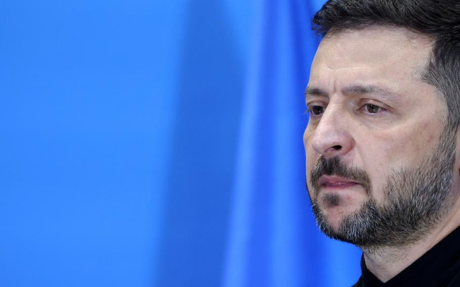 Zelenskyy stares at a crowd.