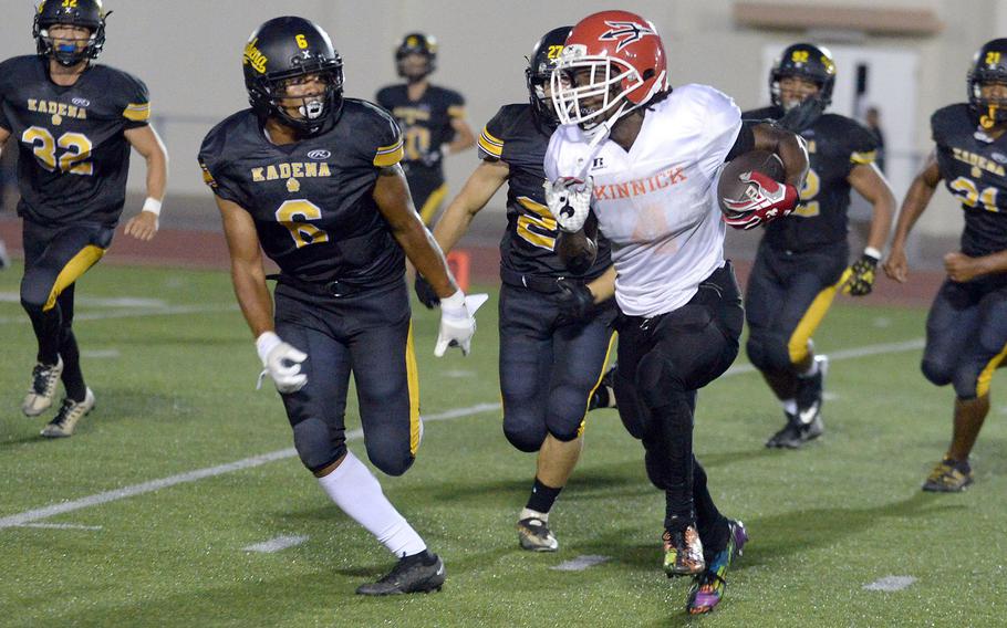 Nile C. Kinnick's Tre Bennett tries to elude Kadena defender Kai Christy.