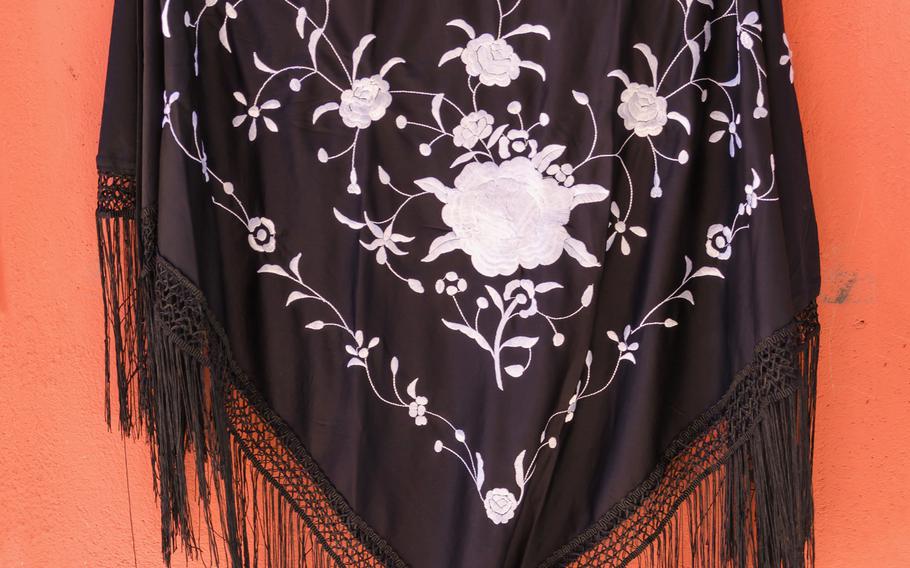 The Spanish shawl, an adaptation of the Manila shawl, is still fashionable.