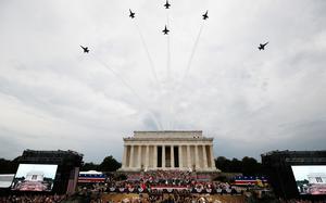 FILE - President Donald Trump, first lady Melania Trump, Vice President Mike Pence and Karen Pence and others stand as the US Army Band performs and the US Navy Blue Angels flyover at the end of an Independence Day celebration in front of the Lincoln Memorial, July 4, 2019, in Washington. (AP Photo/Alex Brandon, File)