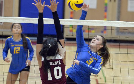 Yokota's Lilly Wellons spikes against Seisen's Aina Sekaido during Tuesday's Kanto Plain volleyball match. The host Phoenix won in three sets. 