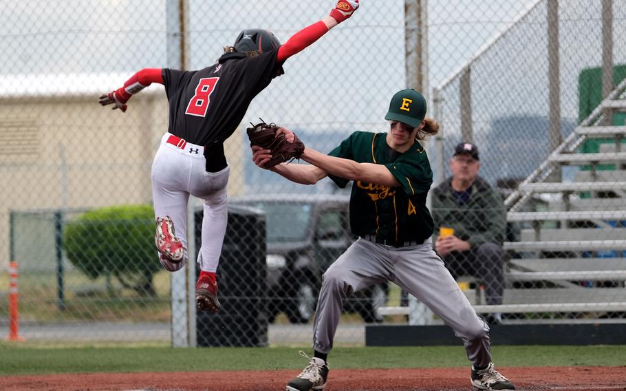 Nile C. Kinnick's Phil Menard tries to avoid the tag of Robert D. Edgren's Parker Kuns at home plate during Saturday's DODEA-Japan baseball game. Menard was eventually tagged out. The Red Devils beat the Eagles 8-1.