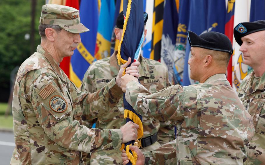 Maj. Gen. Viet X. Luong, right, passes the U.S. Army Japan guidon to U.S. Forces Japan commander Lt. Gen. Kevin Schneider at Camp Zama, Japan, Friday, June 25, 2021. 