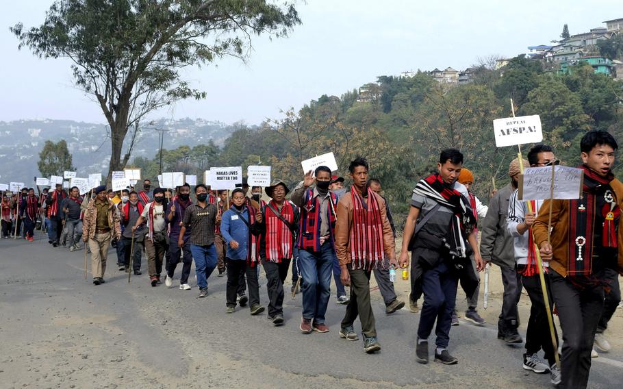 Nagas hold placards in Kohima, northeastern Nagaland state, India, on Tuesday, Jan. 11, 2022, while participating in a 43-mile walk demanding the repeal of the Armed Forces Special Powers Act.