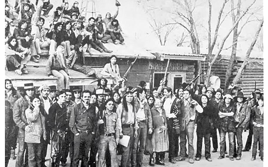 A video screen grab shows members of the American Indian Movement during a February 1973 occupation of Wounded Knee.