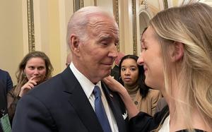 Brittany Alkonis, wife of Navy Lt. Ridge Alkonis, who is imprisoned in Japan, speaks with President Joe Biden following his State of the Union address at the Capitol, Tuesday, Feb. 7, 2023. 