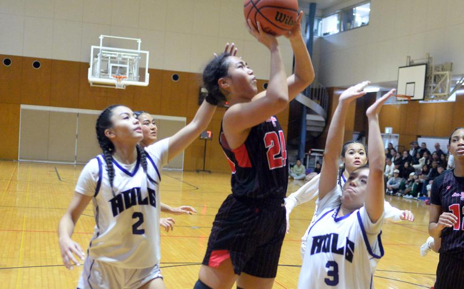 Nile C. Kinnick's Kotone Turner shoots between Academy of Our Lady of Guam's Torie Rapadas and Maddy Ada. The Red Devils won 41-28 to stay unbeaten at 15-0.
