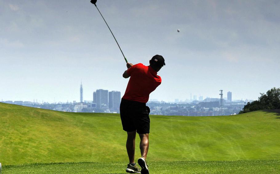 Jason Cosio tees off with Tokyo’s western suburbs in the distance during Sunday’s Day 2 play in the All-Japan Interservice Golf Tournament at Tama Hills Golf Club. Cosio won the tournament’s Seventh Flight.