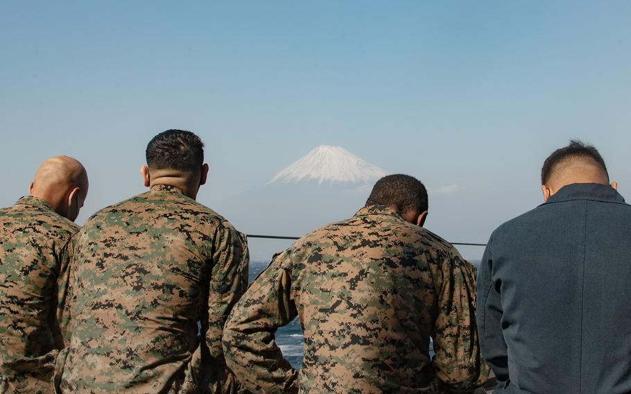 Members of the 31st Marine Expeditionary Unit sail near Mount Fuji aboard the dock landing ship USS Germantown, Feb. 21, 2021. 