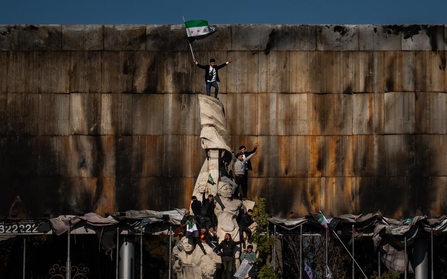 People climbing a statue.